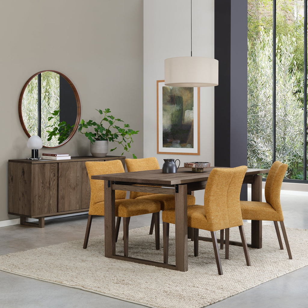 Pair of mustard yellow fabric dining chairs with dark oak legs by Bentley Designs, showcasing stylish and comfortable seating.