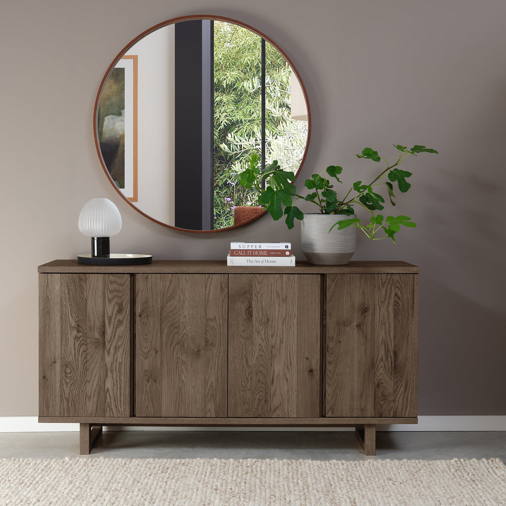 Dark oak Bentley Designs 4-door wide sideboard with two shelves, showcasing a sleek, modern storage piece with ample space.