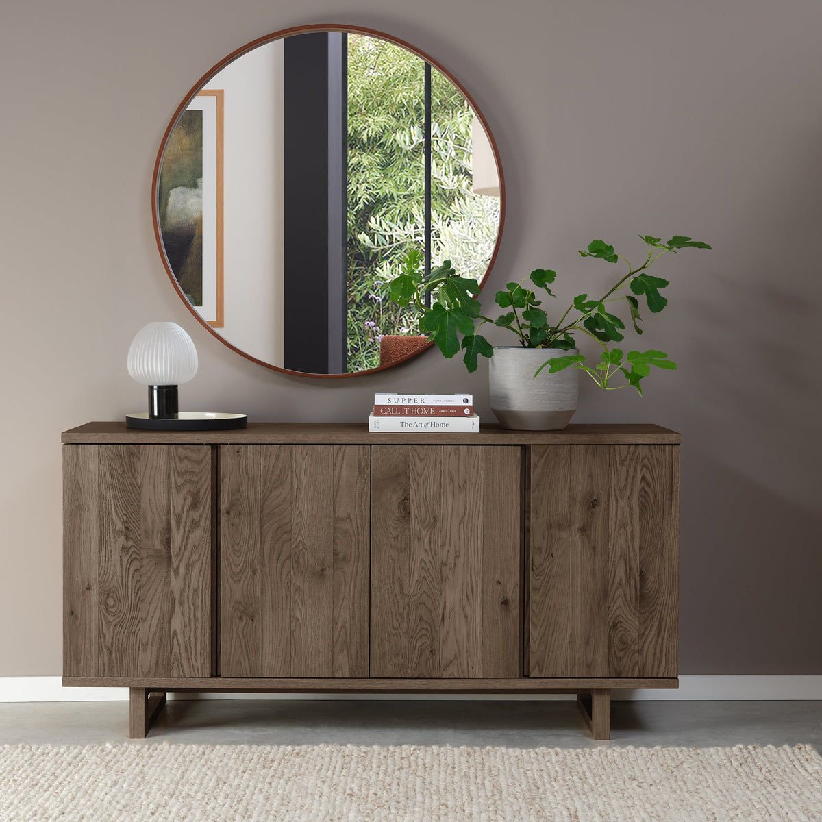 Dark oak Bentley Designs 4-door wide sideboard with two shelves, showcasing a sleek, modern storage piece with ample space.
