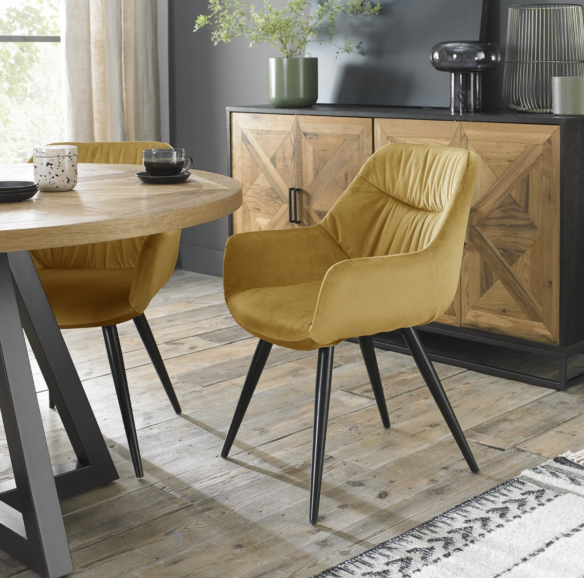 Yellow velvet fabric dining arm chair with pleated back pattern by Bentley Designs, showcasing elegant upholstery and stylish design.