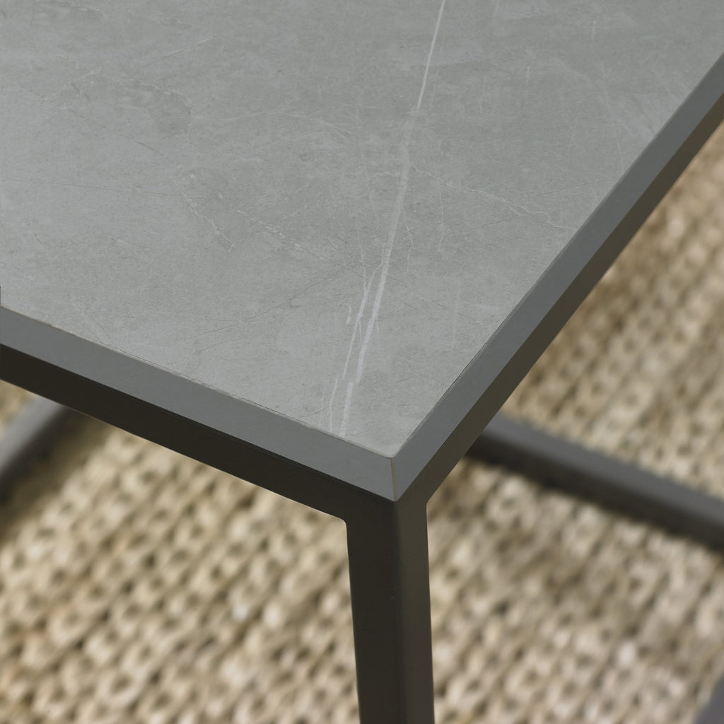 Matt grey marble effect nest of lamp tables with metal frames by Bentley Designs, showing sleek, modern surface and sturdy construction.
