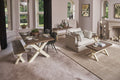 Living room with a wooden dining table and chairs, sofa, and decorative elements.